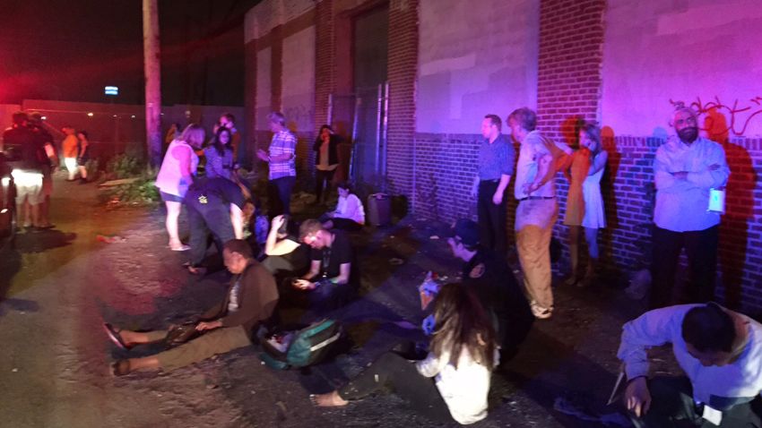 Passengers of an Amtrak train that crashed gather Tuesday, May 12, 2015, near Philadelphia. Train 188 was traveling from Washington to New York City.