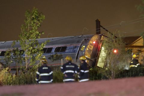 Emergency personnel work the scene of the train wreck on May 12.