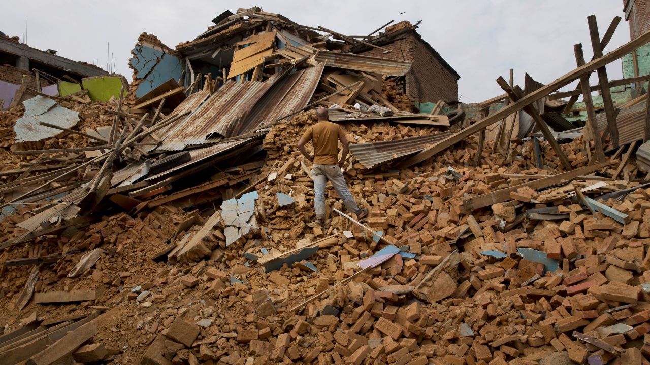A man looks at massive damage in Chautara, Nepal, on Wednesday, May 13.