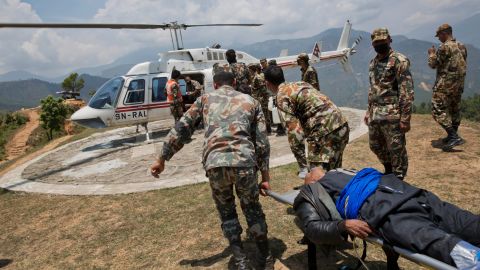 A helicopter waits to evacuate an injured man at a Nepali army base near Chautara on May 13.