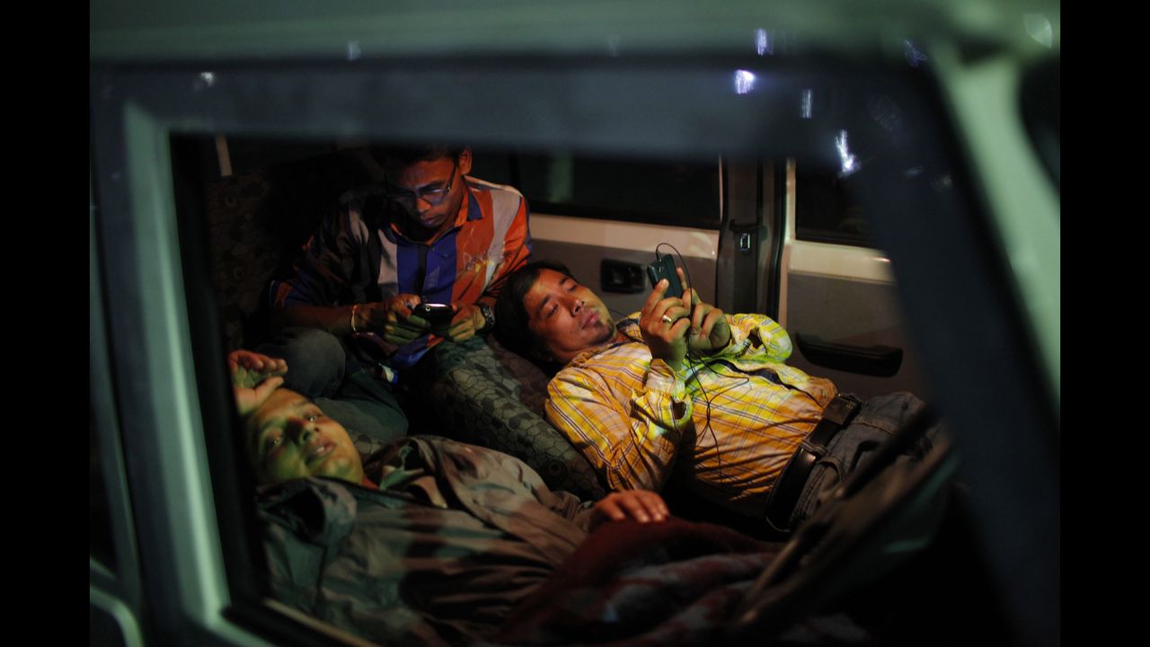People take shelter inside a car instead of being indoors in Kathamandu on May 12.