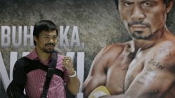 Filipino boxer and Congressman Manny Pacquiao poses for the media following a news conference upon arrival Wednesday, May 13, 2015 at the Ninoy Aquino International Airport at suburban Pasay city south of Manila, Philippines.