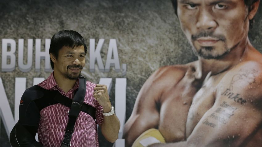 Filipino boxer and Congressman Manny Pacquiao poses for the media following a news conference upon arrival Wednesday, May 13, 2015 at the Ninoy Aquino International Airport at suburban Pasay city south of Manila, Philippines.