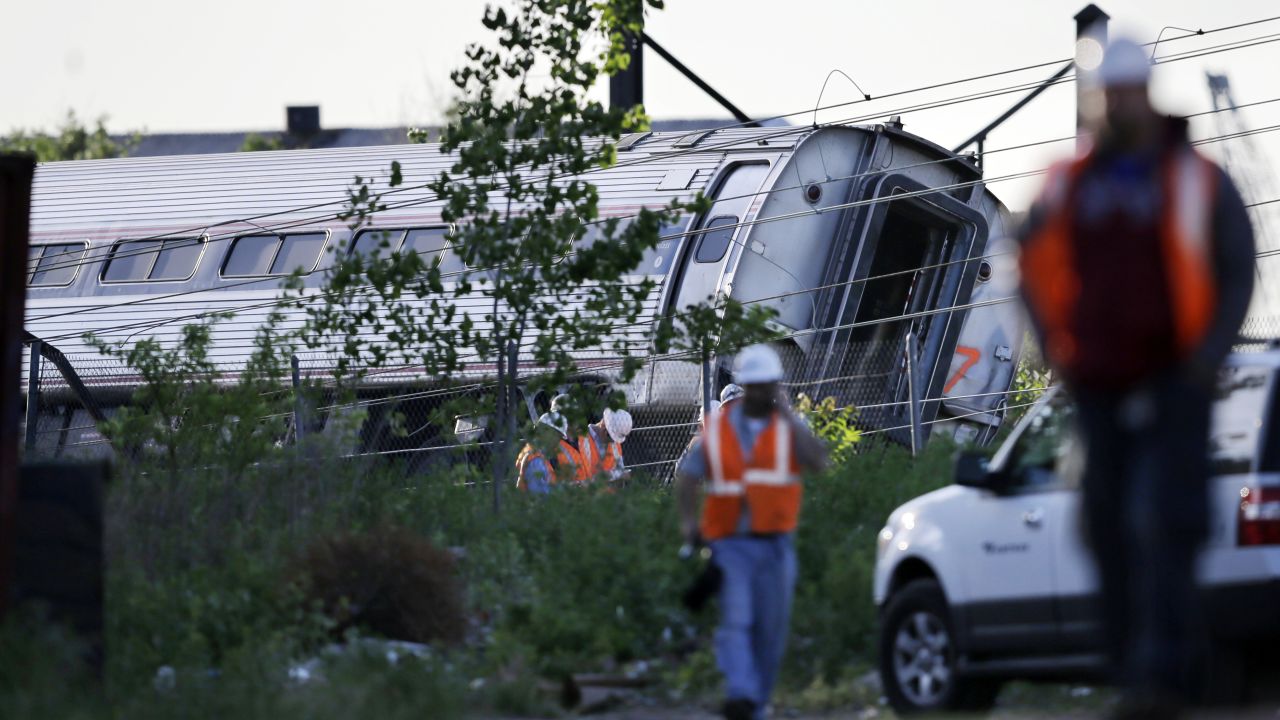 Emergency personnel walk near the scene of a deadly train wreck, Wednesday, May 13, 2015, in Philadelphia. An Amtrak train headed to New York City derailed and crashed in Philadelphia on Tuesday night. (AP Photo/Mel Evans)