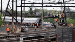 Emergency personnel gather near the scene of a deadly train wreck, Wednesday, May 13, 2015, after a fatal Amtrak derailment Tuesday night, in the Port Richmond section of Philadelphia. Federal investigators arrived Wednesday to determine why an Amtrak train jumped the tracks in a wreck that killed at least six people, and injured dozens. (AP Photo/Mel Evans)