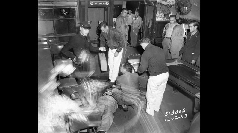 Members of the Los Angeles Police Department work at the scene of a shooting in December 1953. Award-winning crime writer James Ellroy, author of books such as "The Black Dahlia" and "L.A. Confidential," has teamed up with the Los Angeles Police Museum on <a href="index.php?page=&url=http%3A%2F%2Fabramsbooks.com%2FBooks%2FLAPD__53-9781419715853.html" target="_blank" target="_blank">"LAPD '53,"</a> a new book that looks at law enforcement in the city more than 60 years ago. The book will be released on Tuesday, May 19.