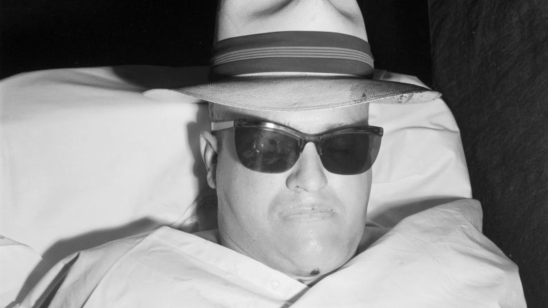 Louis W. Hammert was killed in August 1953, a year after the convicted bank robber was paroled from prison. He was shot by the chief guard of a bank in downtown Los Angeles. "Morgue jockeys, medical examiners and homicide cops are irrepressible cut-ups," Ellroy wrote. "Someone decked Hammert out in shades and a straw fedora."