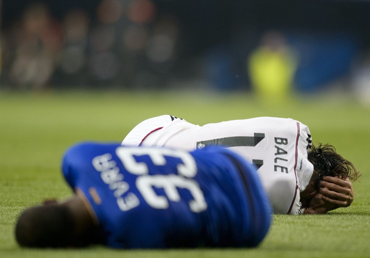 Juventus defender Patrice Evra and Real Madrid's forward Gareth Bale lie on the pitch after a clash of heads.