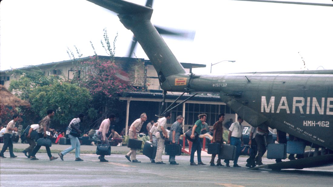 In April 1975, the fall of Saigon to the North Vietnamese effectively marked the end of the Vietnam War. Here, U.S. Marines guard civilians during evacuations at Tan Son Nhut airbase. The country became the Socialist Republic of Vietnam on July 2, 1976.