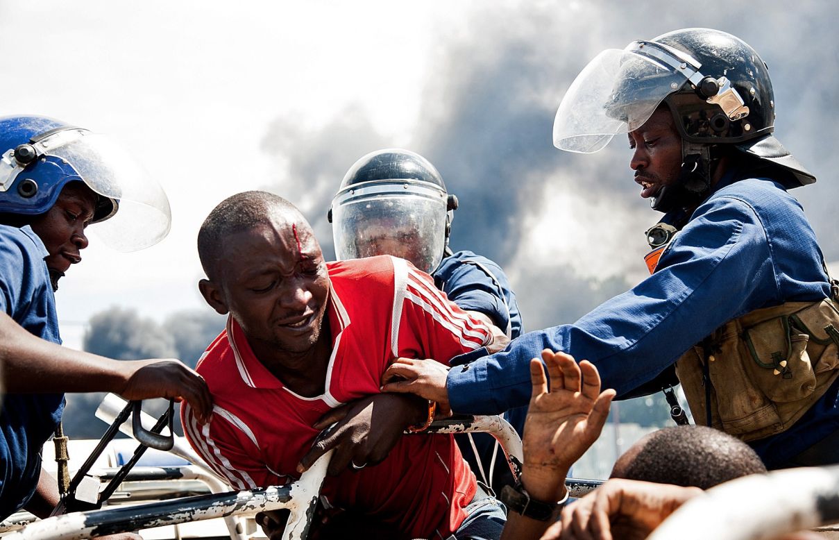 Police grab a man at a protest in Bujumbura on Wednesday, May 13.