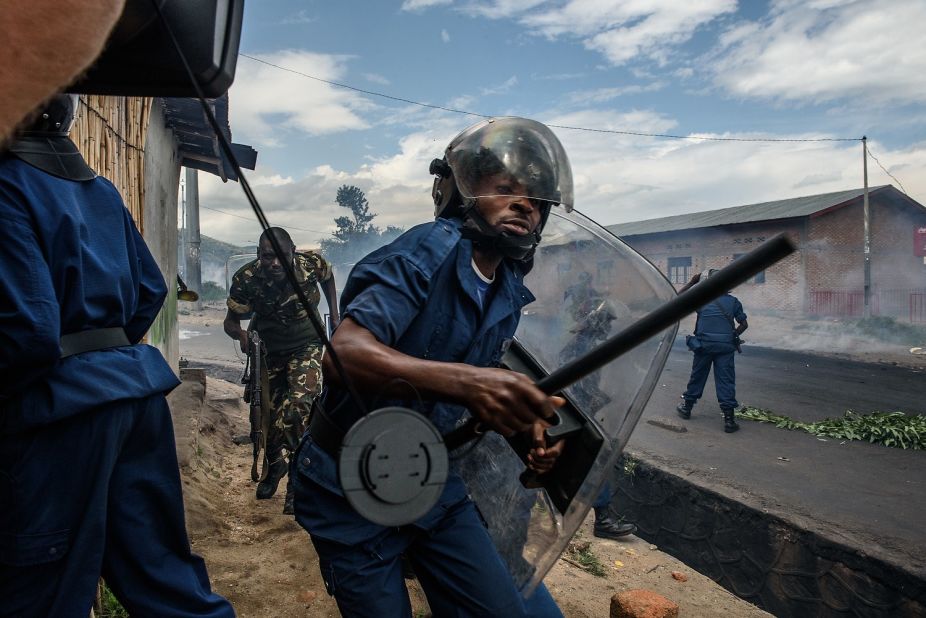 Burundi police and army forces run on May 13 after protesters threw stones during a demonstration in Bujumbura.