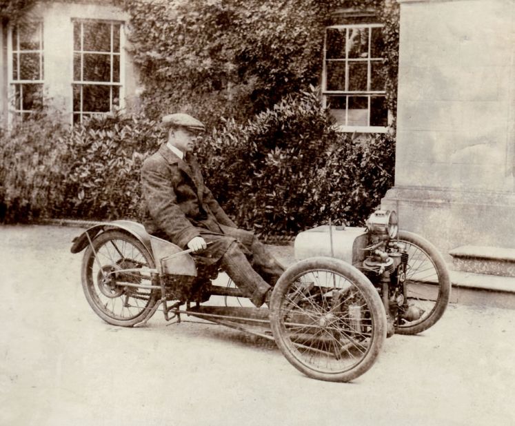 Company founder Henry Morgan with his inaugural three-wheeler design in 1909.