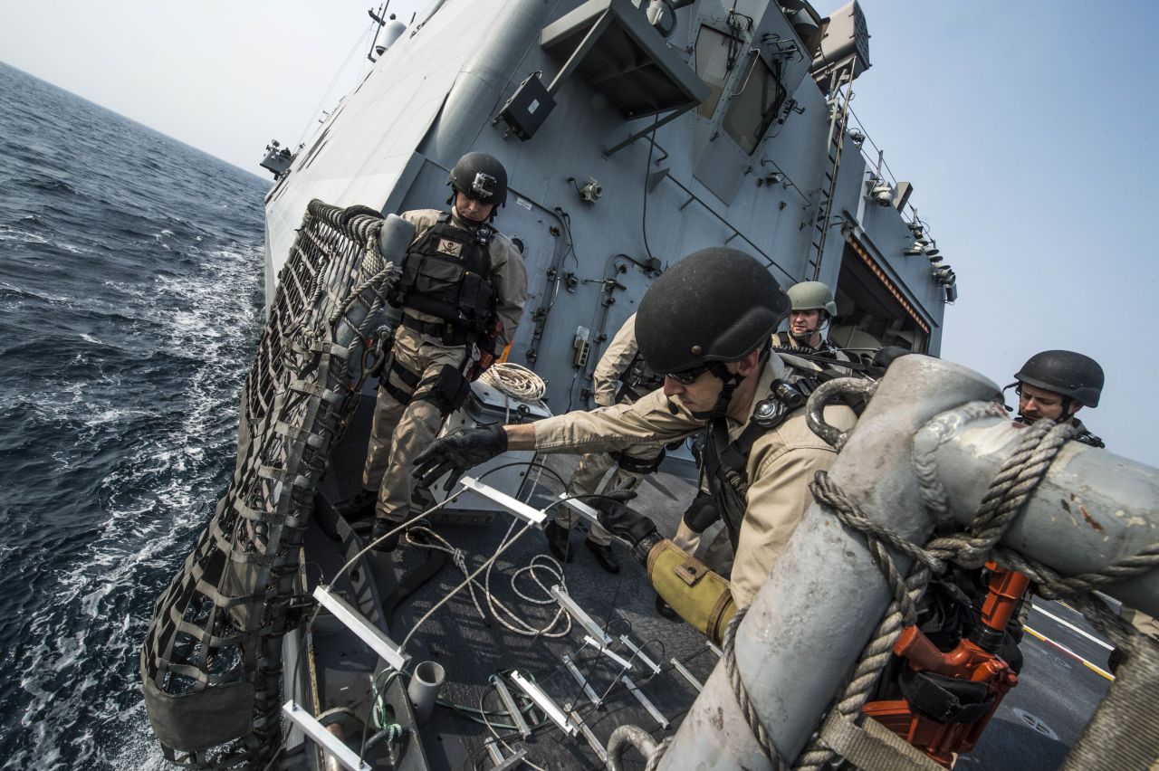 Chief Gunner's Mate Nicholas Bokan, assigned to Surface Warfare Mission Package, Detachment 1, embarked aboard the littoral combat ship USS Fort Worth (LCS 3), rigs a caving ladder on the flight deck during a visit, board, search, and seizure training drill. 