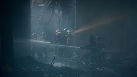 Firefighters tackling the fire that tore through a factory producing footwear in the Philippines on Wednesday.