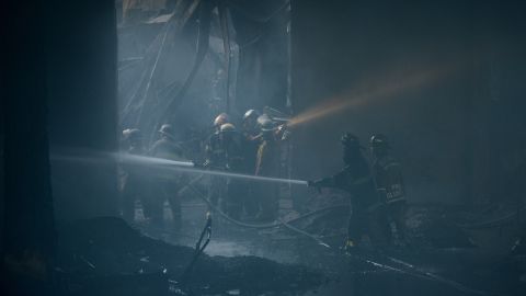 Firefighters tackling the fire that tore through a factory producing footwear in the Philippines on Wednesday.