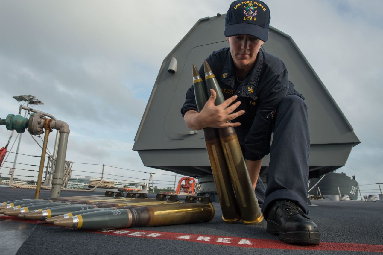 Chief Fire Controlman Beth Simpson-Fuchs moves 57 mm rounds aboard the littoral combat ship USS Fort Worth (LCS 3) while in port at Changi Naval Base Singapore. The 57mm gun is part of the LCS's core ship weapons. 