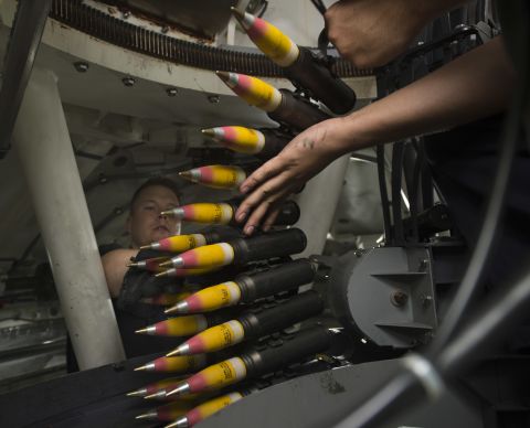 Gunner's Mate 2nd Class Andrew Thomasy and Fire Controlman 1st Class Waylon Clement, assigned to Surface Warfare Detachment 3, load high-explosive incendiary tracer rounds into the ammunition feeder-can of a 30mm weapons system aboard the littoral combat ship USS Fort Worth (LCS 3). The 30mm guns are part of the LCS surface warfare package.