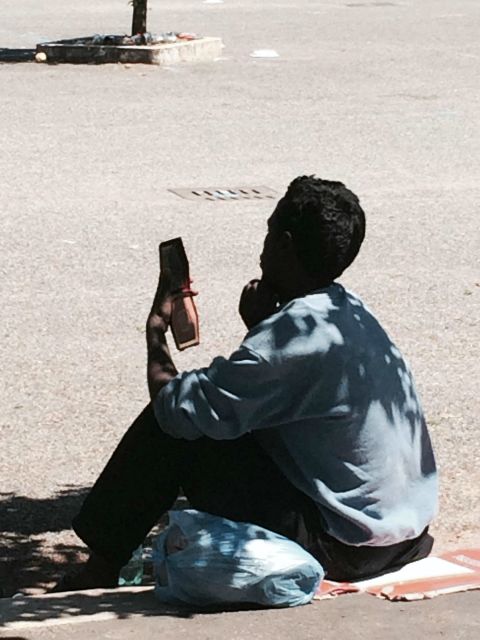 An Eritrean man stares at a cell phone. According to European Union regulations, migrants must be registered in the country they arrive in, and cannot go on to request asylum elsewhere. But many who arrive in Italy flee before they are registered hoping to make it to other European countries. 