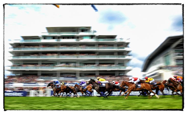 The grandstand is a mere blur as the race action hots up on the turf.