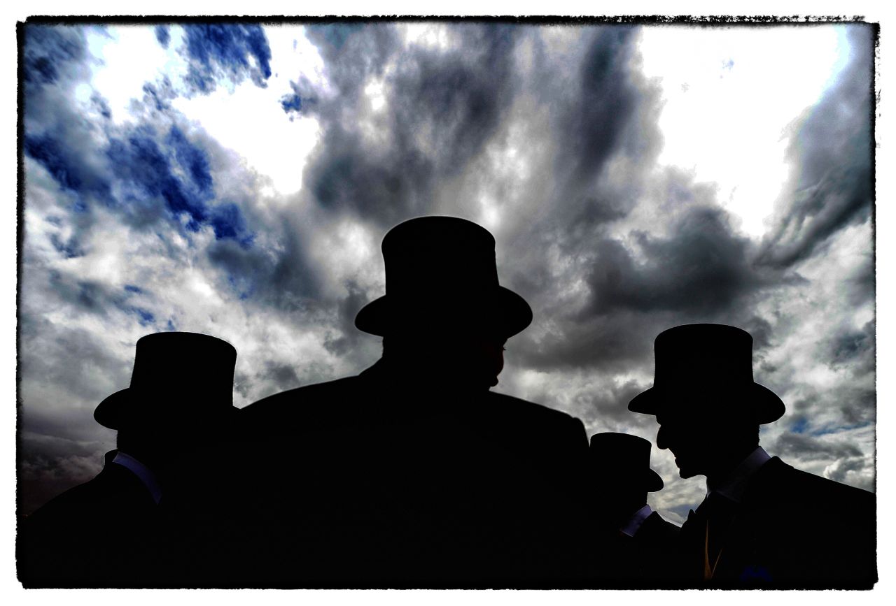 Top hats and tails are in order for gentlemen on race day at Epsom, a short train ride from London.