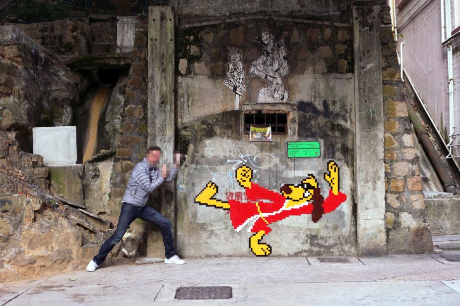 Invader is pictured here with his Hong Kong Phooey in Happy Valley, Hong Kong. The cartoon dog was among the pieces removed in 2014.