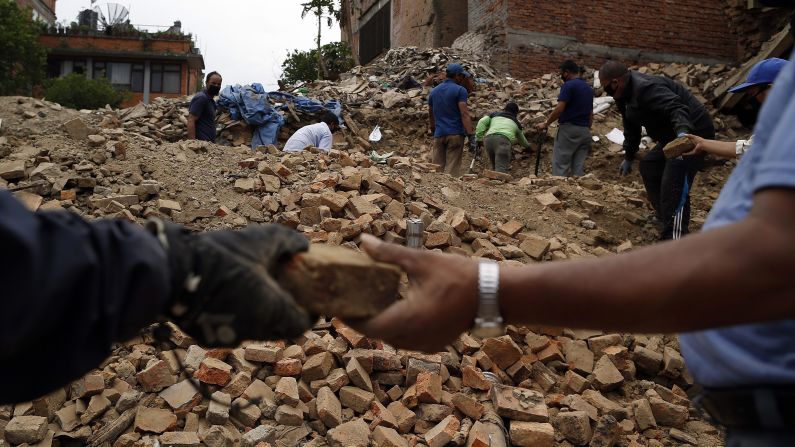 People collect bricks from the ruins of buildings in Bhaktapur, Nepal, on Friday, May 15. The region was struck with a magnitude-7.3 earthquake on Tuesday, May 12, just 17 days after a <a href="index.php?page=&url=http%3A%2F%2Fwww.cnn.com%2F2015%2F04%2F25%2Fworld%2Fgallery%2Fnepal-earthquake%2Findex.html" target="_blank">magnitude-7.8 quake</a> left thousands dead.
