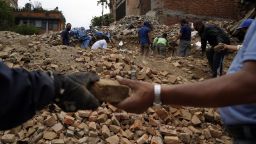 People collect useable bricks from the ruins of buildings in Bhaktapur, Nepal, on Friday, May 15.