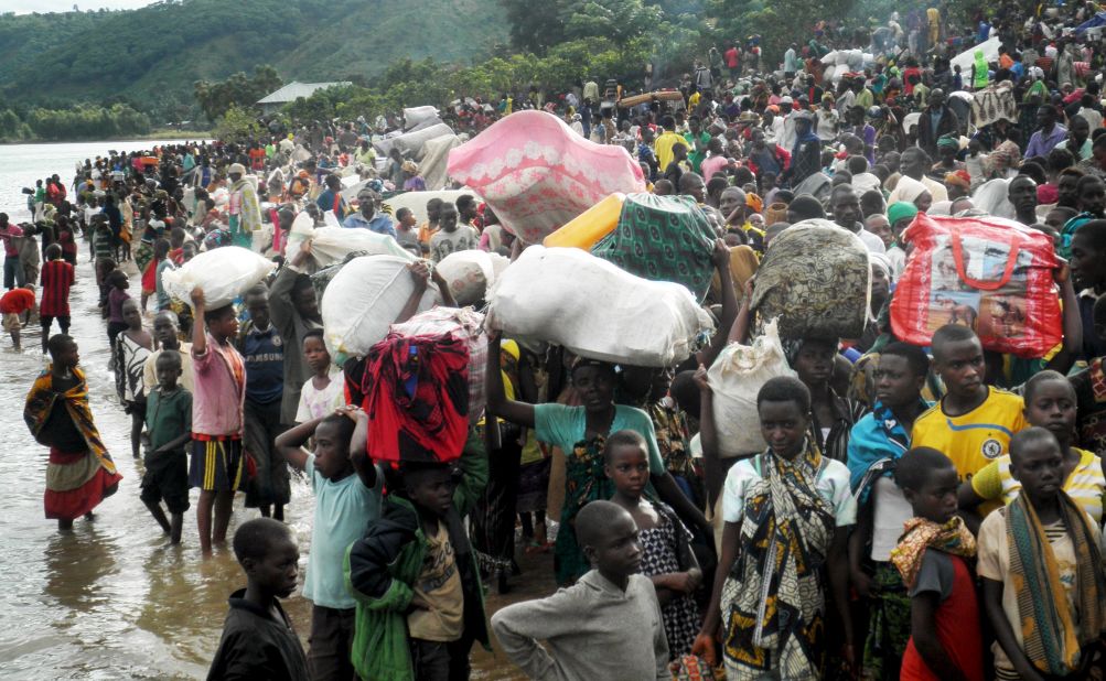 Burundian refugees gather at the shore of Lake Tanganyika in western Tanzania as they wait for a ferry to take them to Kigoma township on Tuesday, May 12. Government officials in Tanzania told local media that at least 80,000 refugees have arrived in Kigoma since Burundi's pre-election skirmishes began.