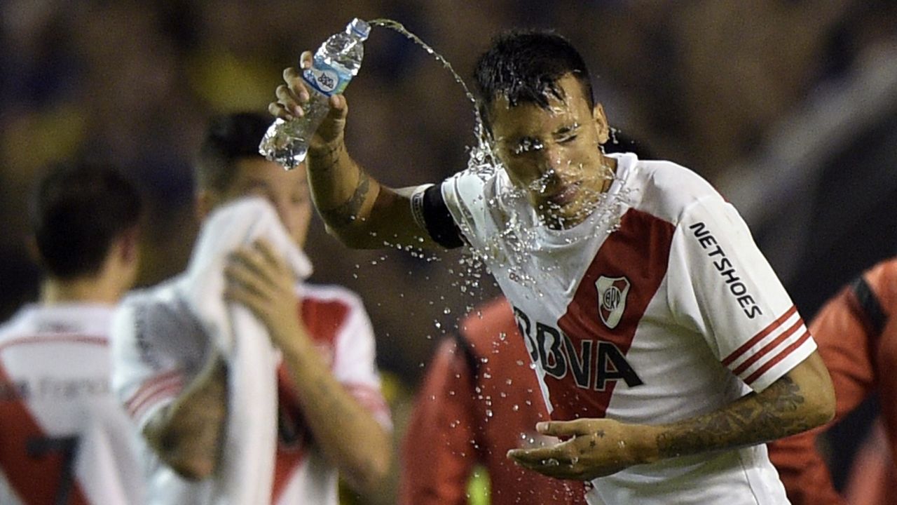 Former River defender Leonel Vangioni pours water on his face after being sprayed in 2015 as her came out for the second half.