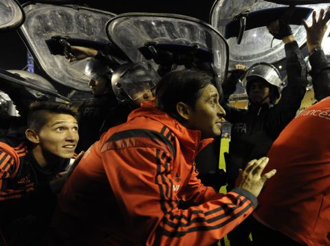 River players had to leave the pitch under police shields after the match as Boca fans threw objects at them.