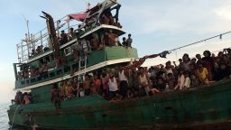 Rohingya migrants sit and stand on a boat drifting in Thai waters off the southern island of Koh Lipe in the Andaman sea on May 14, 2015.  A boat crammed with scores of Rohingya migrants -- including many young children -- was found drifting in Thai waters on May 14, with passengers saying several people had died over the last few days.