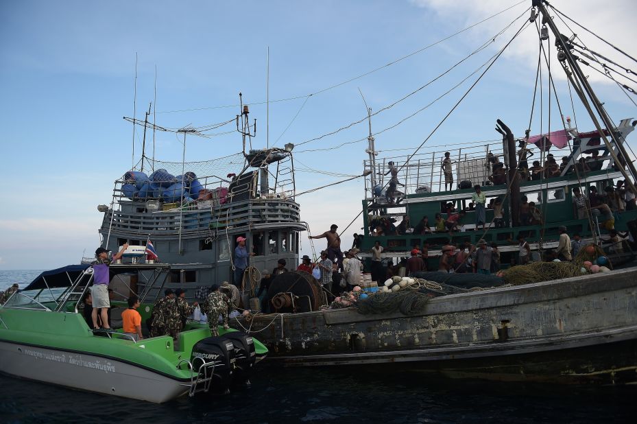 Fishermen and National Park officials provide food supplies to Rohingya migrants stranded on the boat. An Indonesian spokesman said on Wednesday, May 13, that provisions had been given to a migrant boat in the Strait of Malacca before the boat carried on its way to Malaysia -- purportedly the boat's intended destination.