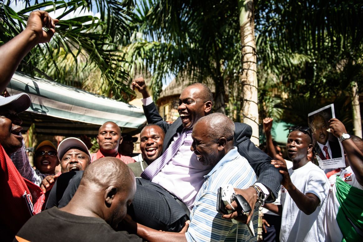 Government spokesman Willy Nyamitwe is carried by supporters in Bujumbura on Friday, May 15, as people celebrate Nkurunziza's return after the failed coup attempt. 