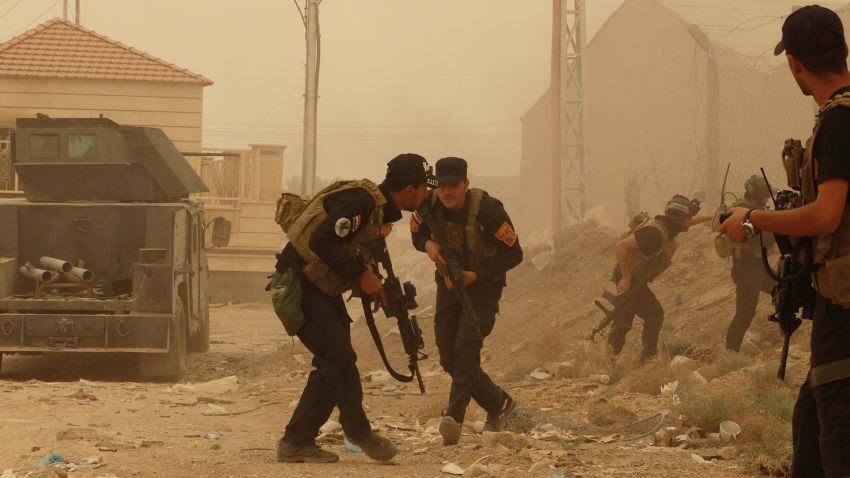 Security forces defend their headquarters against attacks by Islamic State extremists during sand storm in the eastern part of Ramadi, the capital of Anbar province, 115 kilometers (70 miles) west of Baghdad, Iraq, Thursday, May 14, 2015. Islamic State extremists tend to take advantage of bad weather when they attack Iraqi security forces positions, an Iraqi officer said. (AP Photo)