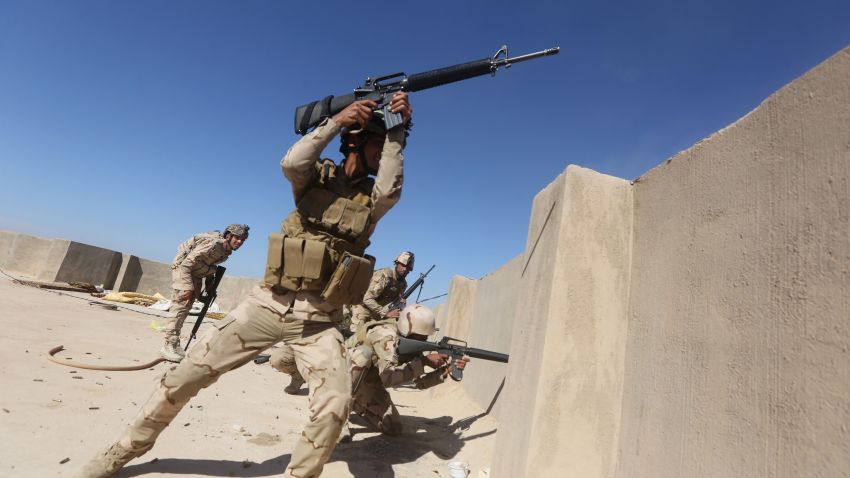 Iraqi soldiers fire their weapons towards Islamic State (IS) group positions in the Garma district, west of the Iraqi capital Baghdad, on April 26, 2015, where pro-government forces say they have recently made advances on areas held by Islamist jihadists. Iraqi security forces control pockets of territory in Anbar, a vast desert province that stretches from the borders with Syria, Jordan and Saudi Arabia to the western approaches to Baghdad. AFP PHOTO/AHMAD AL-RUBAYE (Photo credit should read AHMAD AL-RUBAYE/AFP/Getty Images)