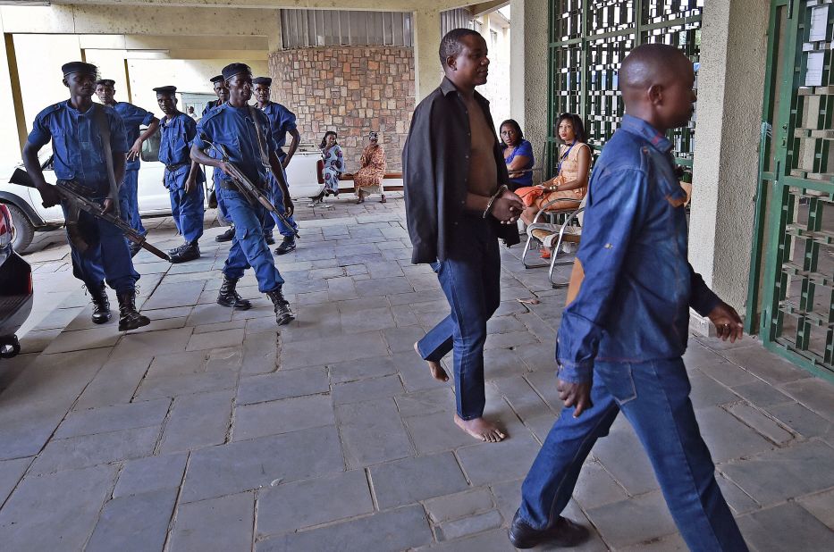 Gen. Niyungeko Juvenal, at center in handcuffs, is taken to the Supreme Court in Bujumbura on May 16. Seventeen alleged coup plotters appeared before a prosecutor.