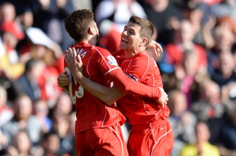 Gerrrard hugs Liverpool goalscorer Adam Lallana but his final home match at Anfield ended in a 3-1 defeat to Crystal Palace.