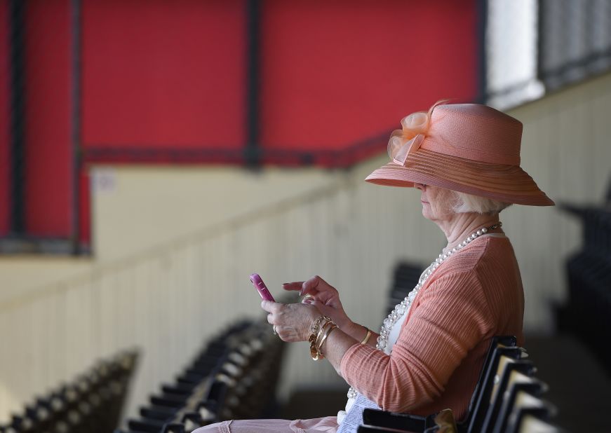 Sandy Wiebel, of Boonsboro, Maryland, looks over her phone in the stands. 