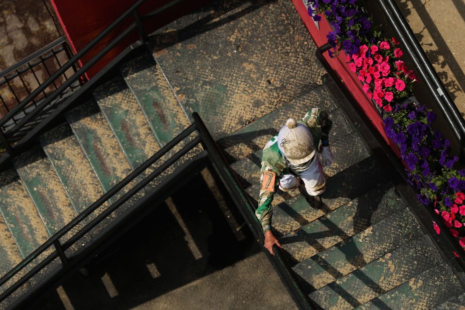 A jockey walks upstairs after a race prior to the running of the Preakness Stakes in Maryland.