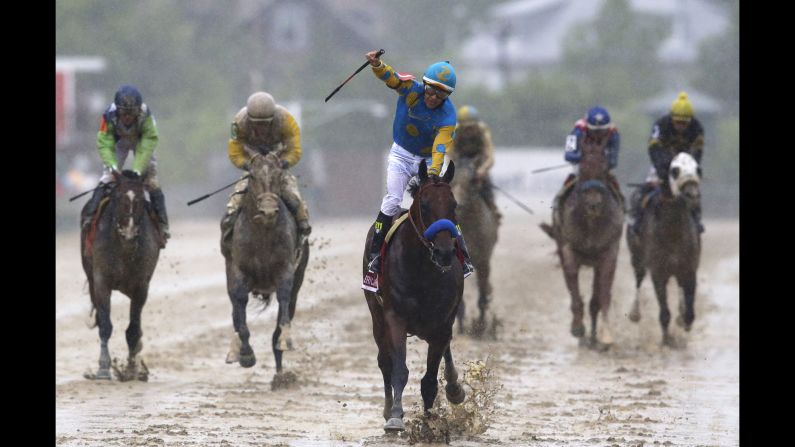 Victor Espinoza exults as he rides Kentucky Derby champ American Pharoah to victory at the Preakness. 