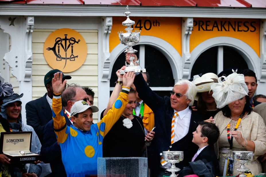 Jockey Victor Espinoza and trainer Bob Baffert celebrate in the winner's circle after American Pharoah won the 140th running of the Preakness Stakes at Pimlico Race Course on Saturday, May 16, in Baltimore, Maryland. 