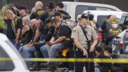 A McLennan County deputy stands guard near the Twin Peaks restaurant in Waco, Texas, where a shootout among rival biker gangs left nine people dead.