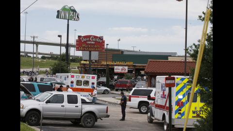 Emergency vehicles and members of law enforcement gather near the scene of the shooting. 