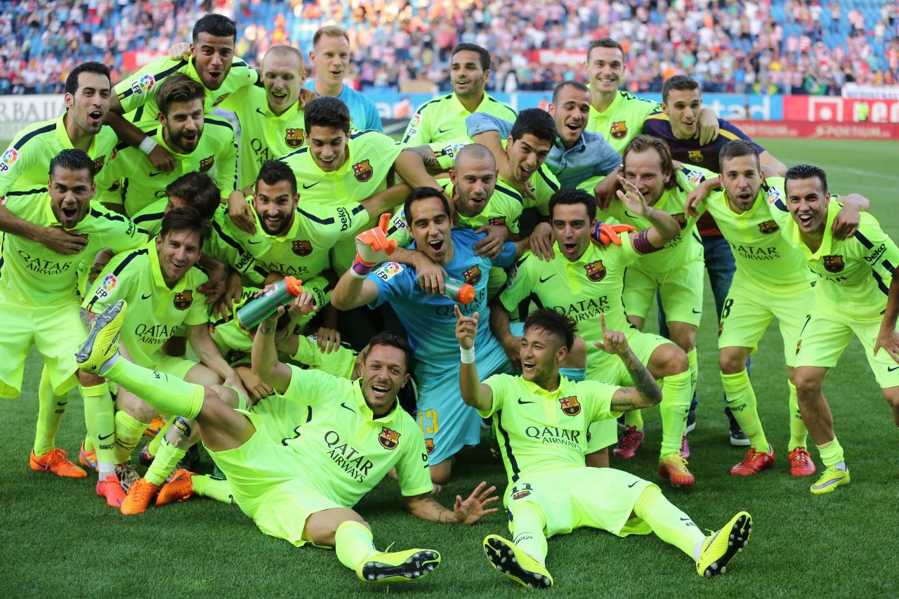 Barcelona players celebrate clinching the La Liga title on the Vicente Calderon pitch.