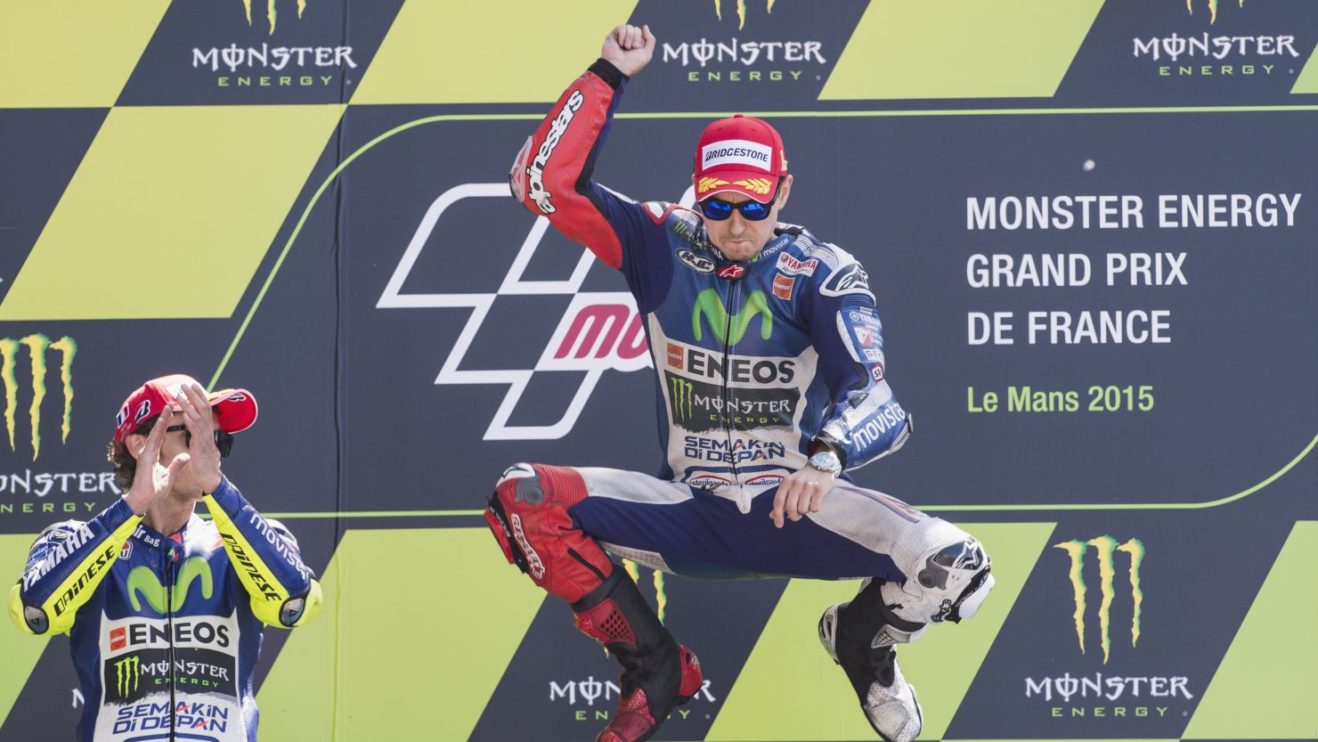 Jorge Lorenzo jumps to celebrate victory on the podium at the MotoGp of France.
