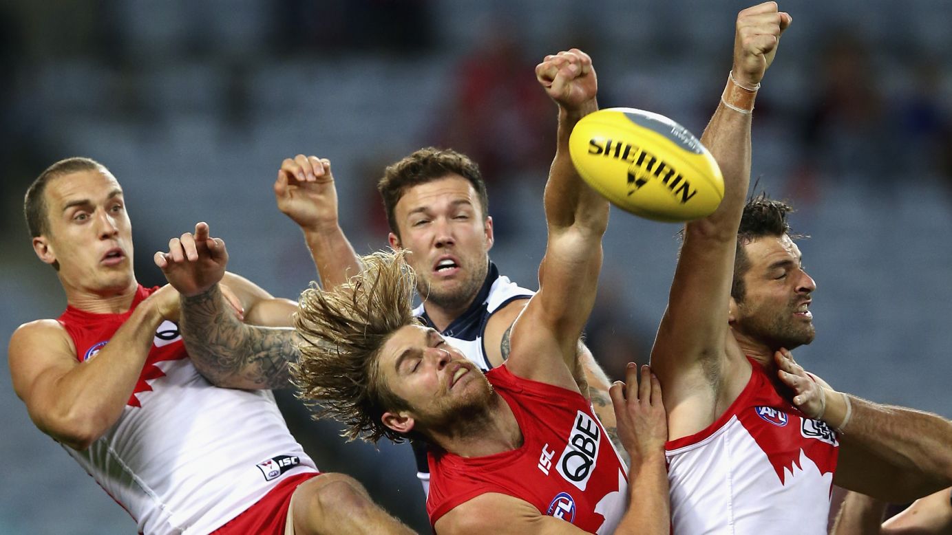 Three of the Sydney Swans -- from left, Ted Richards, Dane Rampe and Heath Grundy -- compete for the ball against Mitch Clark of the Geelong Cats during an Australian Football League match on Saturday, May 16.