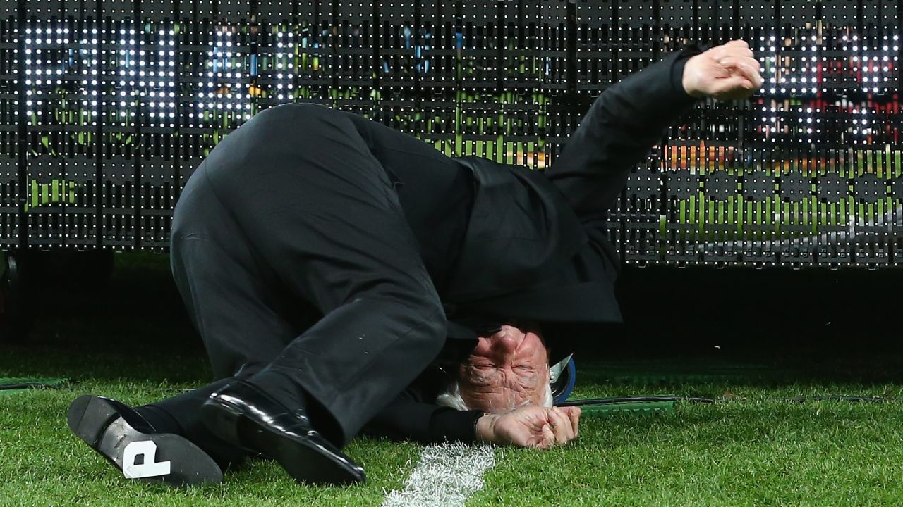 Frank Lowy, chairman of the Australian Football Federation, falls off the stage while presenting the Melbourne Victory with the Grand Final trophy on Sunday, May 17. The 84-year-old was not seriously hurt.