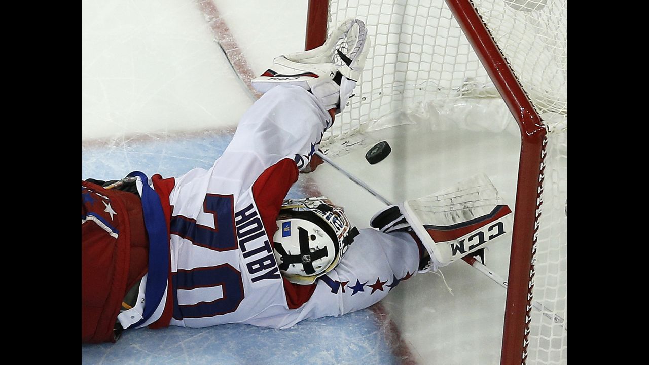The puck gets by Washington goalie Braden Holtby on Wednesday, May 13, lifting the New York Rangers to a dramatic overtime win in Game 7 of the NHL's Eastern Conference semifinals. The series-winning goal was scored by the Rangers' Derek Stepan.