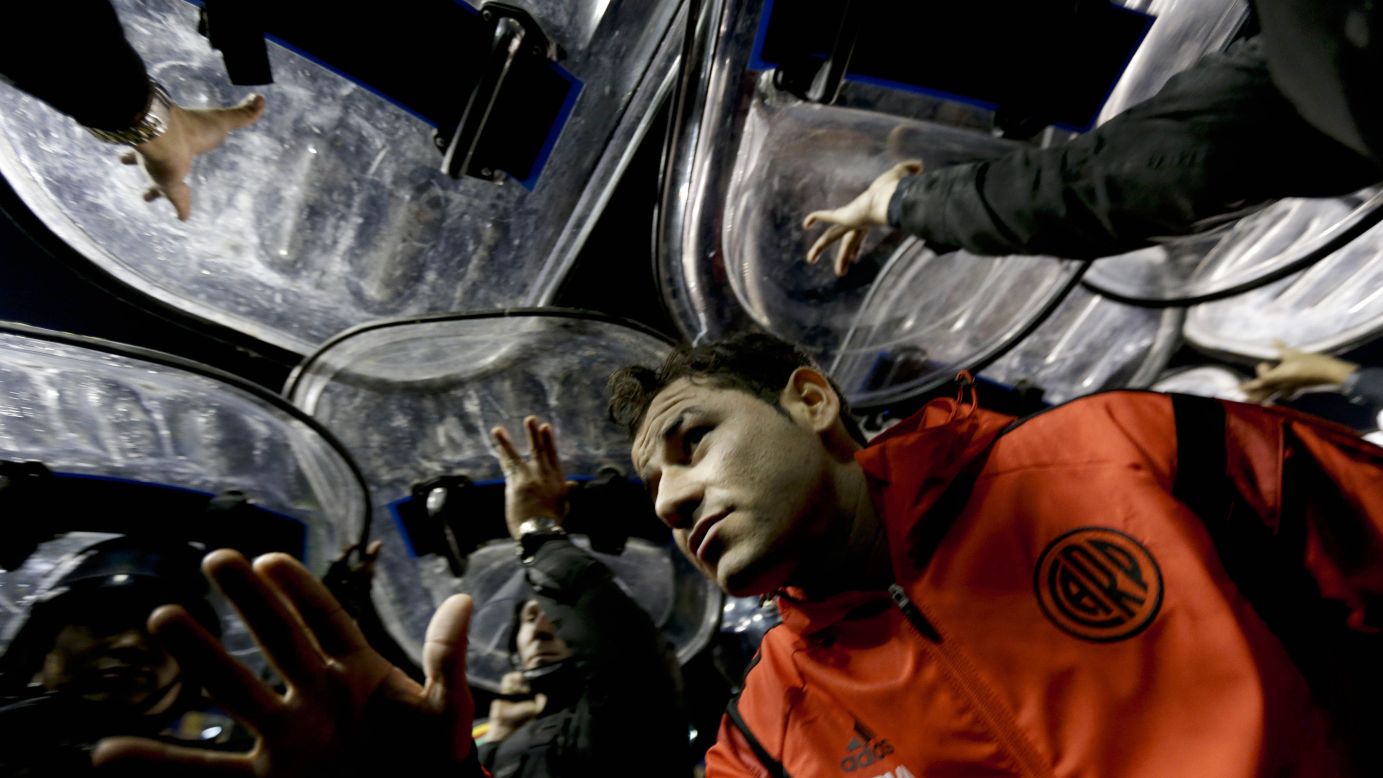 River Plate striker Rodrigo Mora leaves the field under the protection of police shields after a match against rivals Boca Juniors was abandoned Friday, May 15, in Buenos Aires. The match was stopped because four River Plate players <a href="http://www.cnn.com/2015/05/15/football/boca-juniors-river-plate-spray/" target="_blank">were hit with pepper spray</a> as they came out for the second half. In the ensuing chaos, as many as 1,200 police officers were deployed to keep control of the opposing fans.