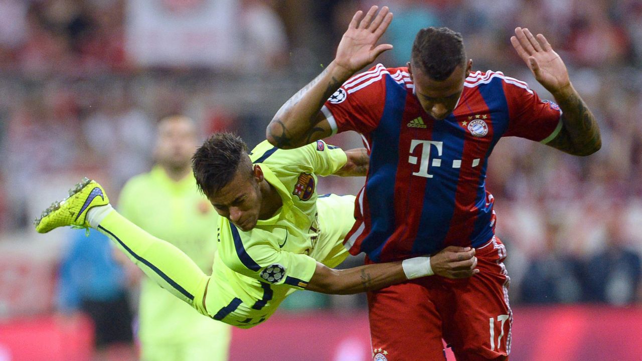 Barcelona's Neymar, left, holds onto Bayern Munich's Jerome Boateng on Tuesday, May 12, during the second leg of their UEFA Champions League semifinal. Bayern won the match 3-2, but Barcelona advanced to the tournament final with an aggregate score of 5-3.